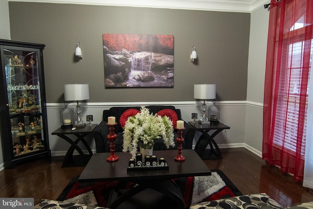 living room with crown molding, baseboards, and wood finished floors