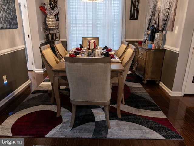 dining space featuring baseboards and dark wood-type flooring