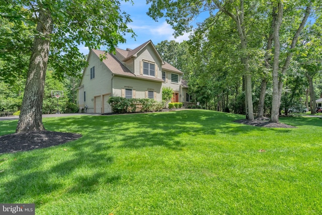 view of front of home with a garage and a front yard