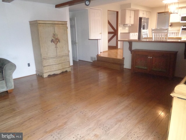 living room with wood finished floors and beamed ceiling