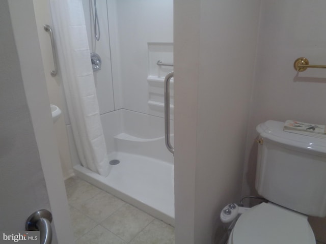 full bath with toilet, a shower stall, and tile patterned floors