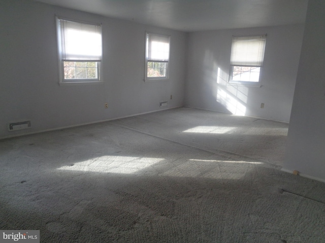 spare room with carpet and visible vents