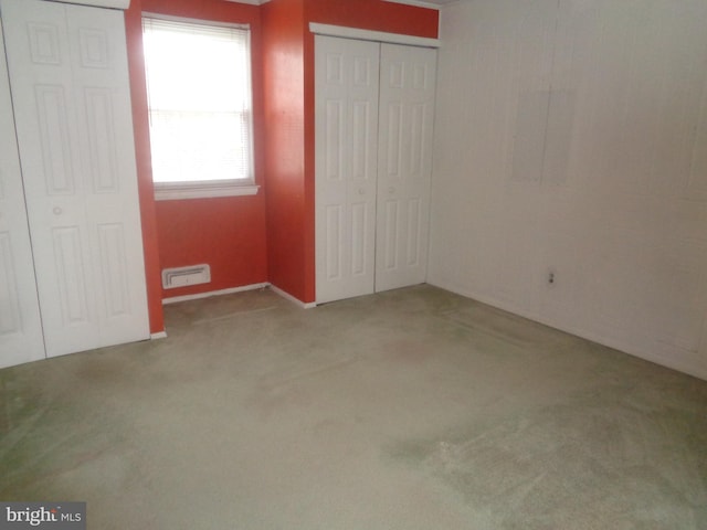 unfurnished bedroom with carpet floors and visible vents