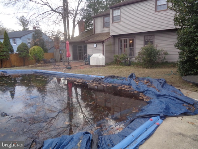 view of swimming pool with area for grilling, fence, and a fenced in pool