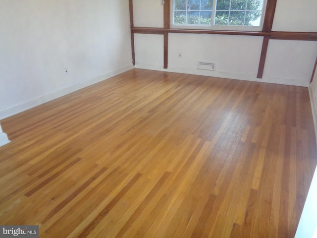 unfurnished room featuring light wood-style flooring and baseboards