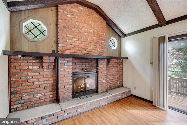details with wood finished floors, beam ceiling, baseboards, and a textured ceiling