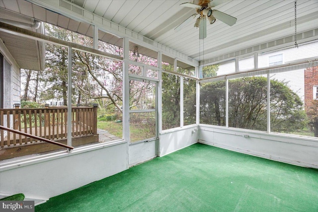 unfurnished sunroom with ceiling fan