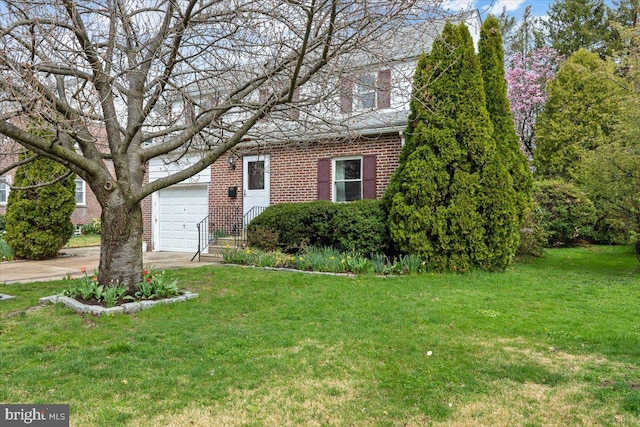 view of property hidden behind natural elements featuring brick siding, driveway, and a front lawn