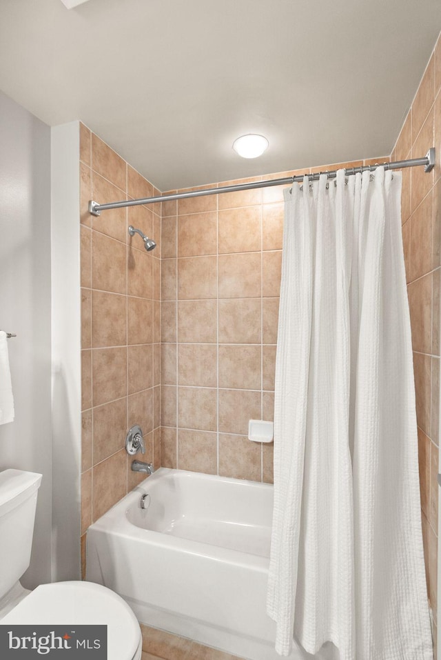 bathroom with toilet and shower / bath combo