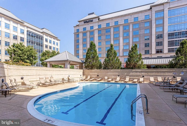 pool featuring a patio and fence