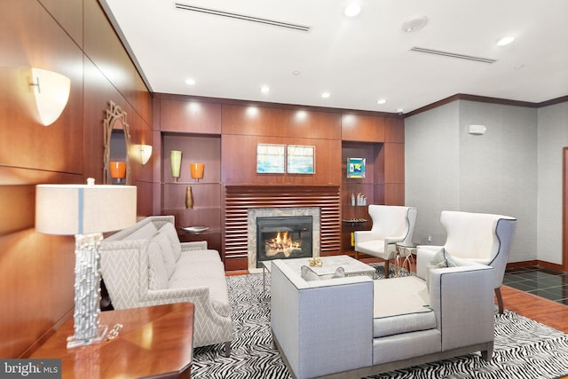 living area with ornamental molding, a fireplace, visible vents, and recessed lighting