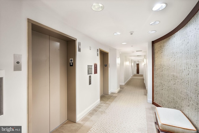 corridor with recessed lighting, elevator, and baseboards