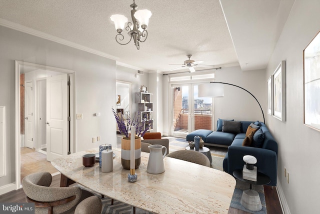 dining area with crown molding, a textured ceiling, wood finished floors, baseboards, and ceiling fan with notable chandelier