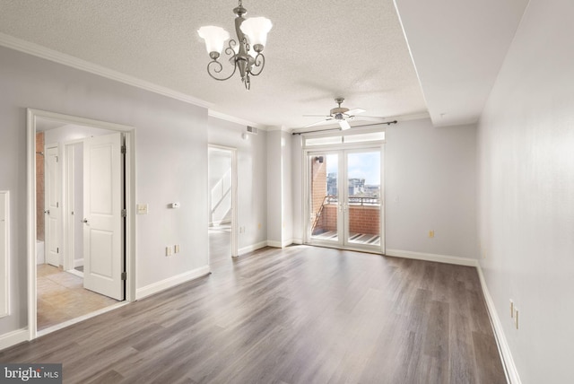 empty room featuring crown molding, a textured ceiling, baseboards, and wood finished floors