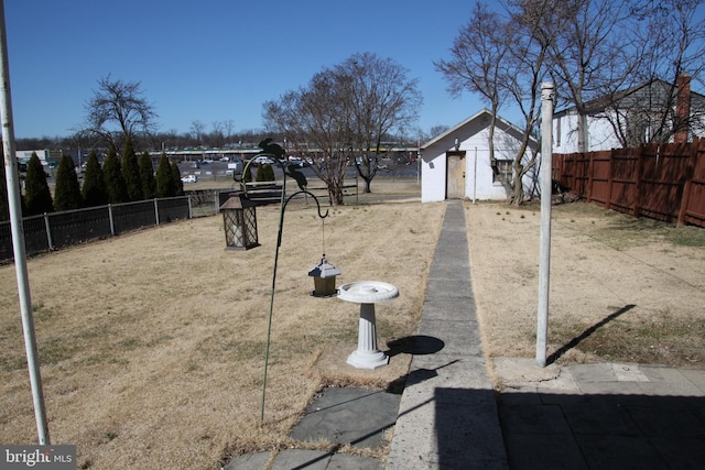 view of yard featuring an outbuilding and a fenced backyard