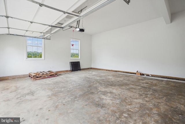 garage with baseboards and a garage door opener