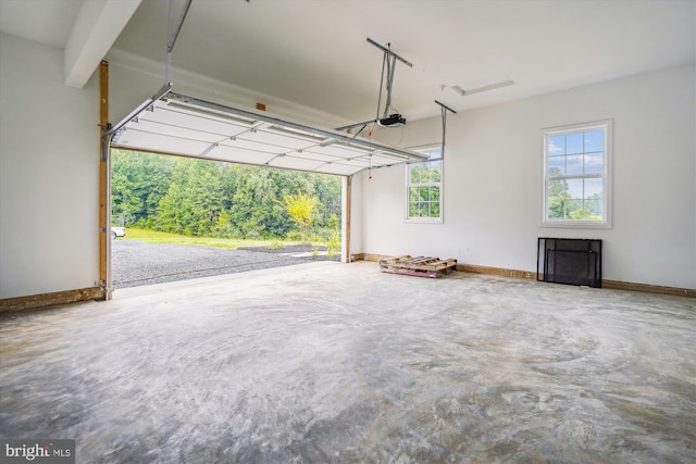 garage with a garage door opener and baseboards