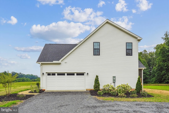 view of property exterior featuring a garage, a shingled roof, and gravel driveway