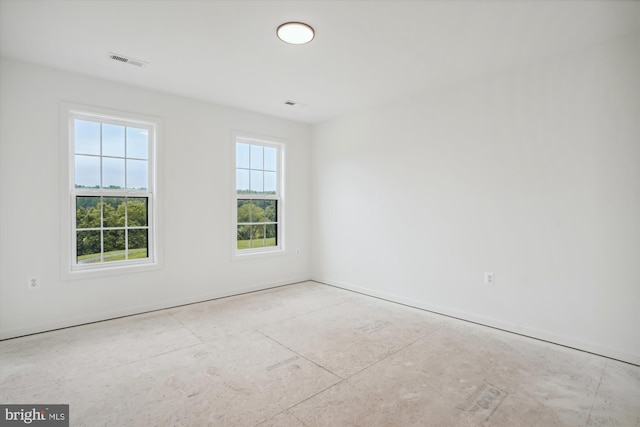 unfurnished room featuring visible vents