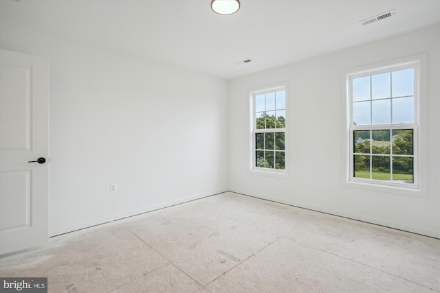 empty room featuring a healthy amount of sunlight and visible vents