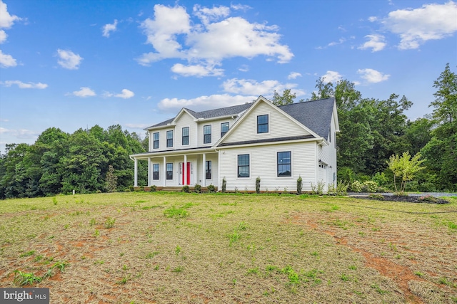 view of front of house with covered porch and a front yard