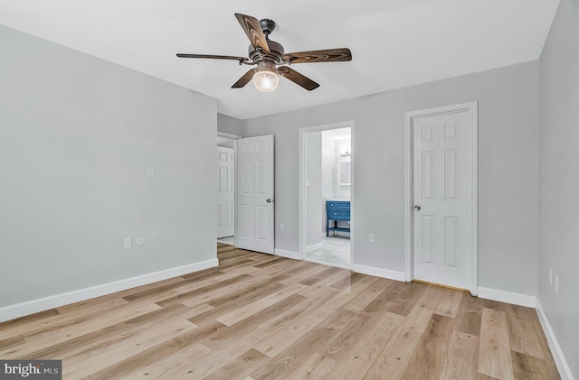 unfurnished bedroom with a ceiling fan, light wood-style flooring, baseboards, and connected bathroom