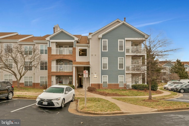 view of property featuring uncovered parking