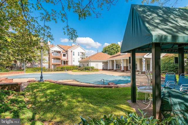 view of pool with a fenced in pool, a patio area, and a lawn