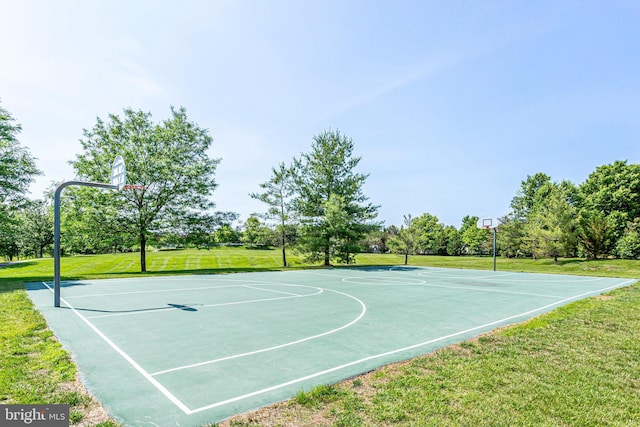 view of basketball court featuring community basketball court and a lawn