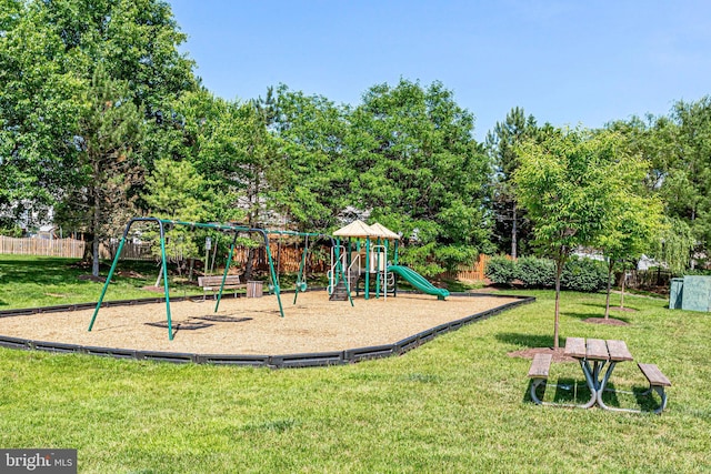 community jungle gym featuring a yard and fence