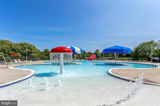 community pool featuring a patio area and fence