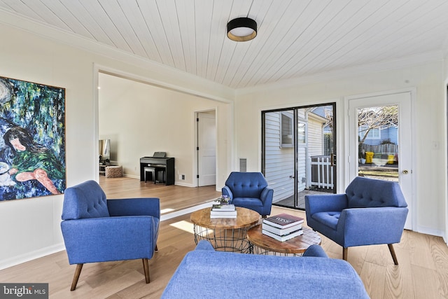 sitting room featuring wood ceiling, light wood-style flooring, visible vents, and crown molding