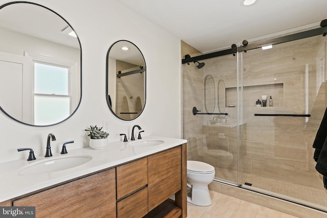 full bath featuring toilet, a shower stall, and a sink