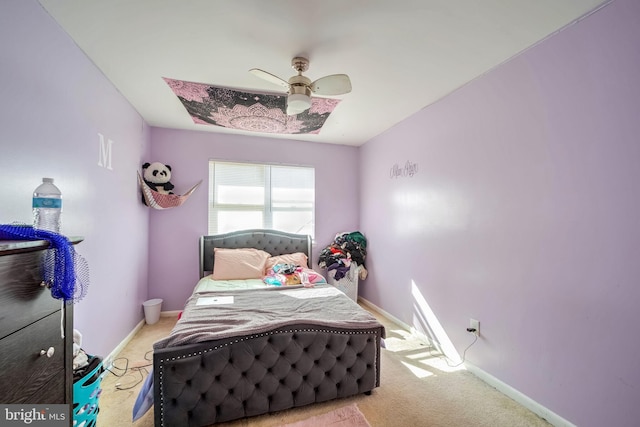 bedroom with ceiling fan, carpet, and baseboards