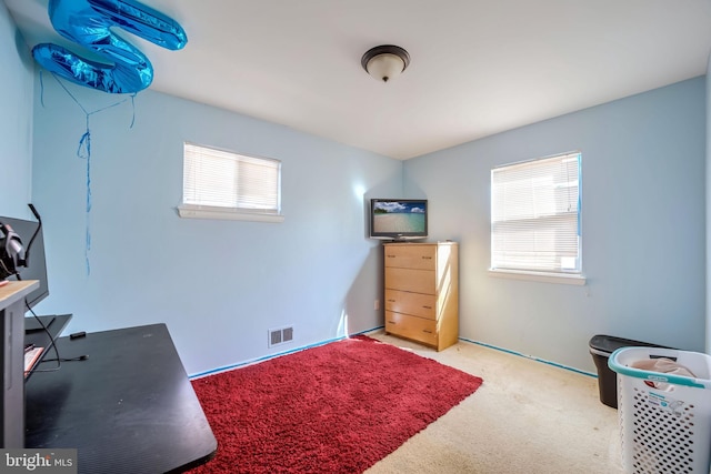 carpeted home office featuring visible vents