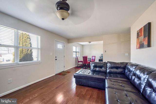 living area with baseboards and wood finished floors