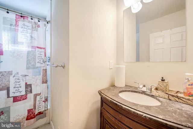 full bath with a shower with shower curtain and vanity