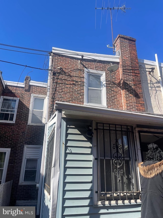 view of property exterior featuring brick siding