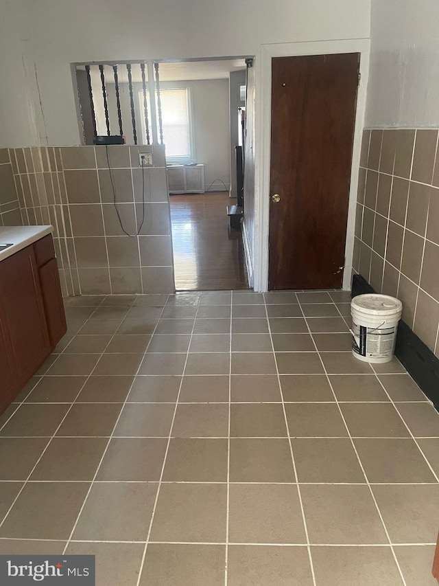 bathroom featuring tile patterned flooring and tile walls