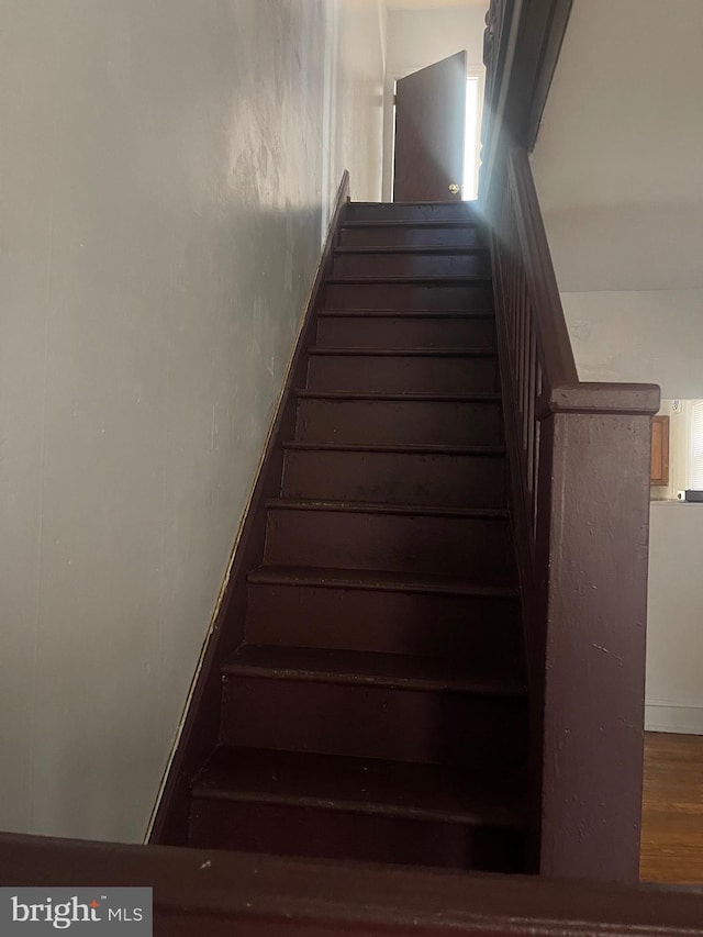 stairway with wood finished floors