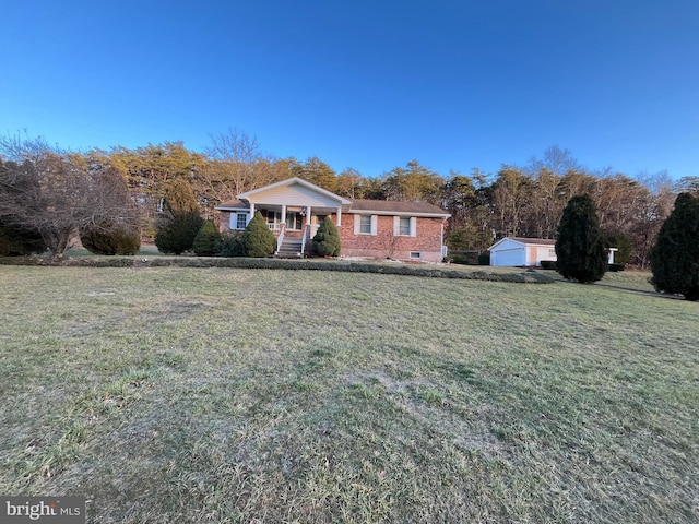 view of front of house featuring covered porch, crawl space, a front yard, and an outdoor structure