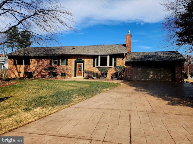 view of front facade with driveway, a garage, a chimney, a front yard, and brick siding