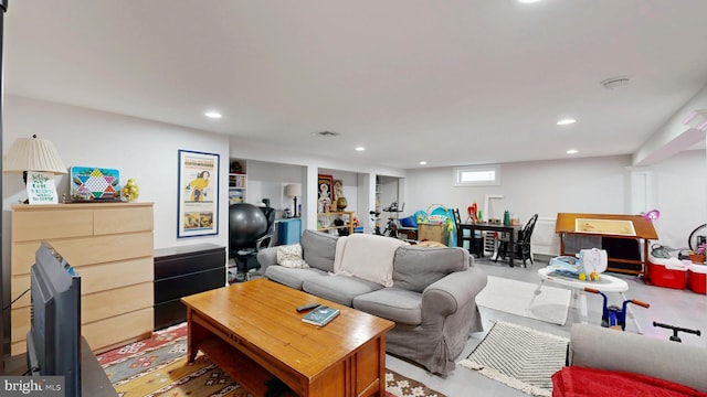 living area with concrete flooring, visible vents, and recessed lighting