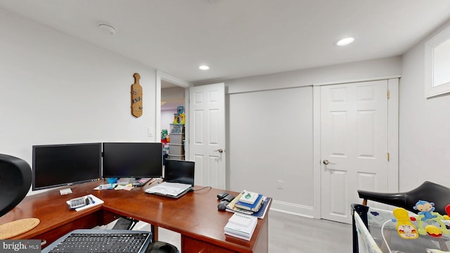 home office with light wood-style flooring and recessed lighting