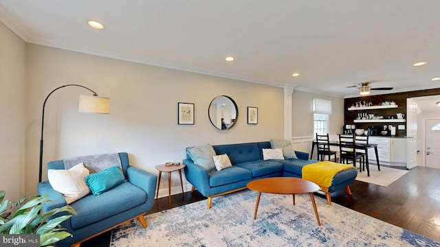 living area with crown molding, recessed lighting, decorative columns, and wood finished floors