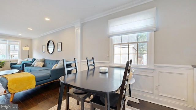 dining space featuring a wainscoted wall, dark wood-style flooring, recessed lighting, and crown molding