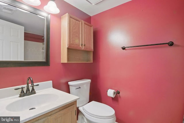 bathroom with visible vents, toilet, and vanity