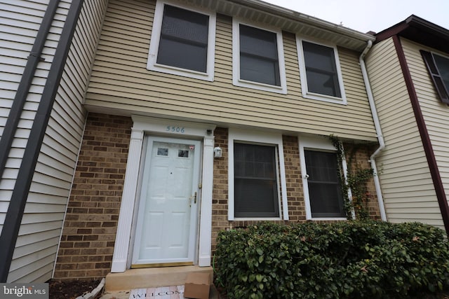 entrance to property with brick siding