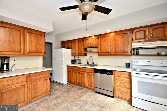 kitchen featuring brown cabinets, light countertops, a sink, white appliances, and under cabinet range hood