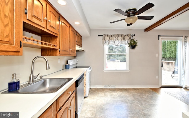 kitchen with a wealth of natural light, white electric range, a sink, and stainless steel dishwasher